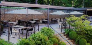 a group of tables and chairs with umbrellas at Hotel Tomášov in Zlín