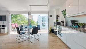 une cuisine et une salle à manger avec une table et des chaises dans l'établissement Ferienwohnung Meeschendorf, à Fehmarn