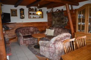 a living room with two couches and a table at Chata U Serifa in Stružinec