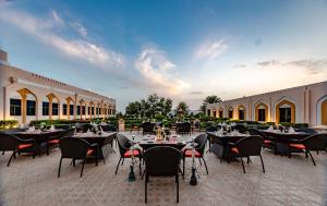 A restaurant or other place to eat at Golden Tulip Nizwa Hotel