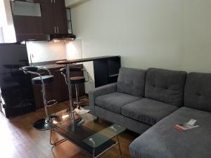 a living room with a couch and a table at KVA Syariah 2BR 1211 in Bekasi