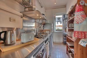 a kitchen with a stove and a counter top at Jesolo sea front garden apartment in Lido di Jesolo