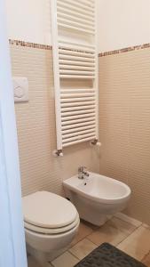 a bathroom with a toilet and a sink at Appartamento Bellini in Martina Franca