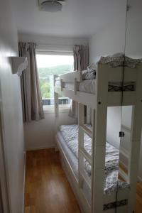 a room with two bunk beds and a window at Fjelltun Fritidsleiligheter, leilighet 407 in Geilo