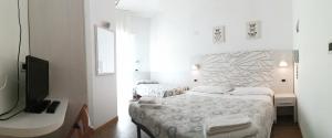 Postel nebo postele na pokoji v ubytování Hotel Luana