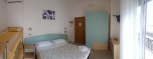 Postel nebo postele na pokoji v ubytování Hotel Luana