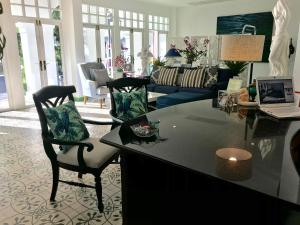 a living room with a table and chairs and a couch at Casa Blanca Boutique Hotel - SHA Plus in Phuket