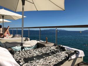 a group of beds on a boat in the water at La Dolce Vita Abbazia in Opatija