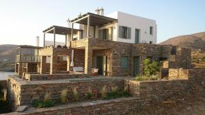 a house on a hill with a brick wall at Sea Shelter in Koundouros