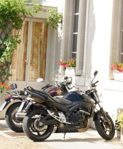 
a black motorcycle parked in front of a building at Hotel Montsegur in Carcassonne

