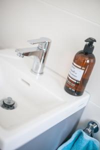 a bottle of soap sitting on a bathroom sink at Gränna Lakeview in Gränna