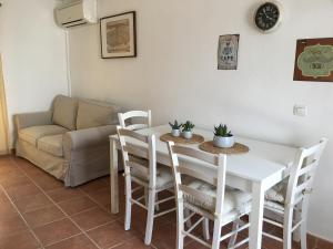 a living room with a table and chairs and a couch at Apartamento Turístico Catherine in Trujillo +13 photos