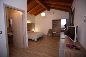 Кровать или кровати в номере Agriturismo al Riparo dai Venti