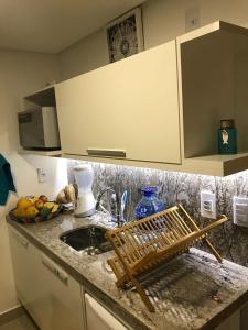 a kitchen counter with a sink and a bowl of fruit at Canto da Sereia in João Pessoa