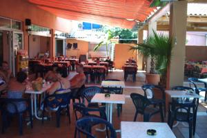 a group of people sitting at tables in a restaurant at Vias Plage Camping Salisses in Vias +52 photos