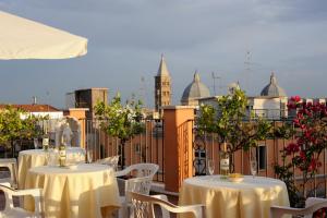uma fila de mesas e cadeiras com vista para uma cidade em Hotel Torino em Roma