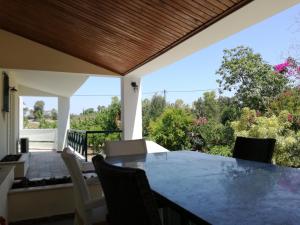 a dining room with a table and chairs on a patio at Villa Irene in Kos