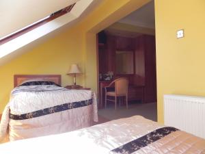 a bedroom with a bed and a table with a chair at Shelmalier House in Athlone