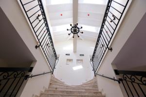 a staircase in a building with a chandelier at Grand Alaçatı Butik Hotel in Alaçatı