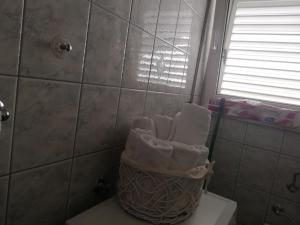 a bathroom with a toilet with towels on it at Apartmani Marija in Primošten +19 photos