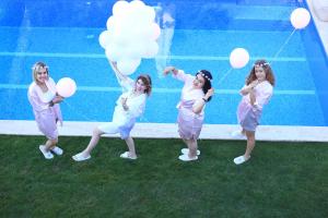 a group of girls standing in front of a wall with balloons at Grand Alaçatı Butik Hotel in Alaçatı +37 photos