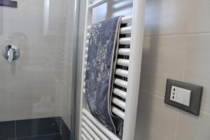 a bathroom with a shower with a blue towel at Casa Andreina in Toscolano Maderno +33 photos