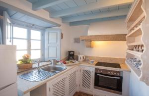 a kitchen with a sink and a stove at Theologos Houses in Grikos