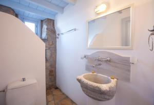 a bathroom with a bowl sink on the wall at Theologos Houses in Grikos