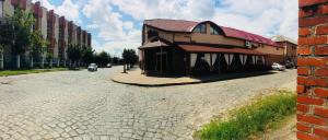 a building on the side of a brick street at Bolero plus in Mukacheve