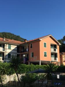 a building with palm trees in front of it at Smeraldo in Levanto
