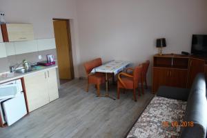 a kitchen with a table and chairs in a room at Domki-Apartamenty HALS in Władysławowo
