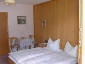 a bedroom with a bed and a table and chairs at Haus Michael in Oetz +13 photos