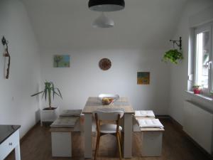 a dining room with a table and a chair at R&G APARTMENT in Žirovnica