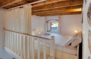 a bedroom with a bed and a window at Theologos Houses in Grikos