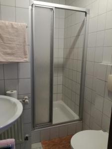 a bathroom with a shower with a tub and a sink at Zeesener Gasthof in Königs Wusterhausen +3 photos