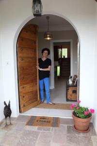 a woman standing in the doorway of a house at Gure Lana in Saint-Jean-Pied-de-Port