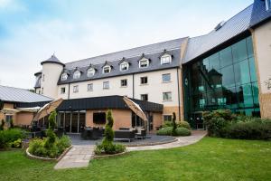 an exterior view of a building with a courtyard at Drayton Manor Hotel in Tamworth