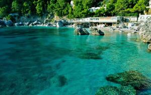 rzeka z niebieską wodą, skałami i mostem w obiekcie Casa del Mare w mieście Capri