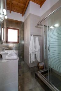 a bathroom with a shower and a sink at Emerald Dream Luxury in Faliraki