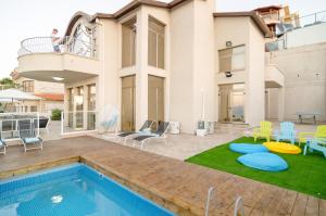 a house with a swimming pool in the yard at Blue Sky Villa view in Tiberias