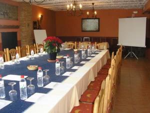 a long table in a room with bottles on it at Hotel Palacio Guzmanes in Baños de la Encina