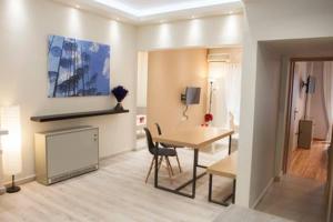 a room with a desk and a table in a room at Modern Central Apartment in Thessaloniki