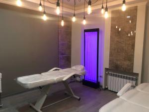 a hospital room with a purple door and a table at Astor Hotel & Spa in Bishkek