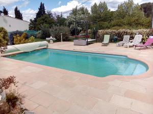 a swimming pool in a yard with chairs and a patio at Casa Lucia in Saint-Maximin-la-Sainte-Baume