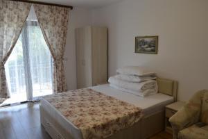 a bedroom with a bed with a stack of towels at Pensiunea Indra in Gura Humorului +61 photos