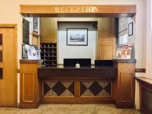 a bar in a restaurant with a sign that reads reception at The Beverley House Hotel in London