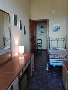 a room with two beds and a dresser with a mirror at Appartamento Felix in Scarlino