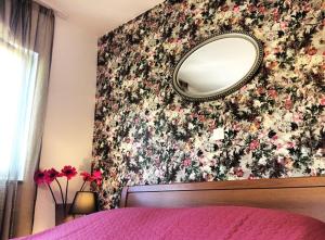 a bedroom with a bed and a mirror on the wall at Faros oasis in Gdinj