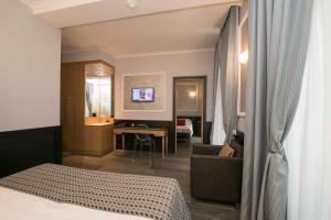 A bed or beds in a room at DK Suites
