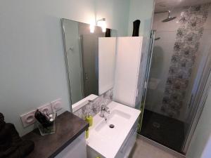 a white bathroom with a shower and a sink at Gite ARCADIA in Saint-Ambroix +27 photos